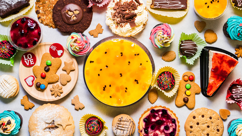 Top-down view of assortment of desserts on white table