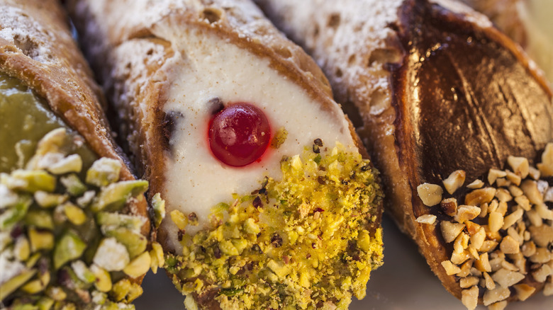 a close-up of three different cannoli varieties side by side