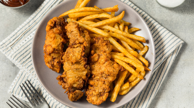 Finger steaks in white bowl with french fries