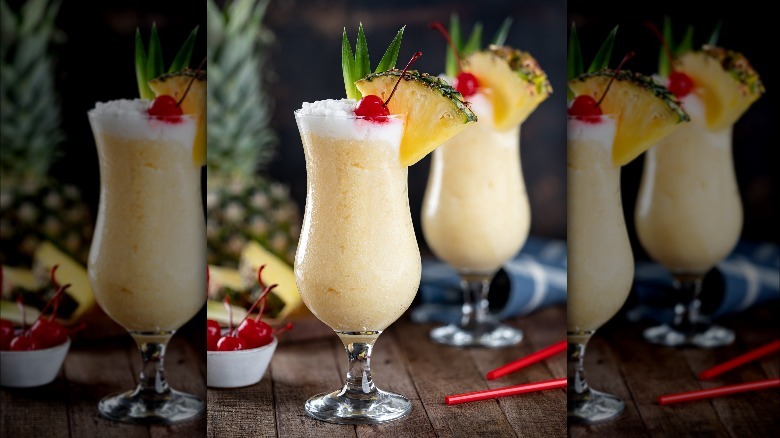 Piña coladas with cherries and pineapple slices