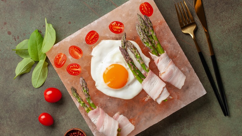 Eggs and bacon on salt block