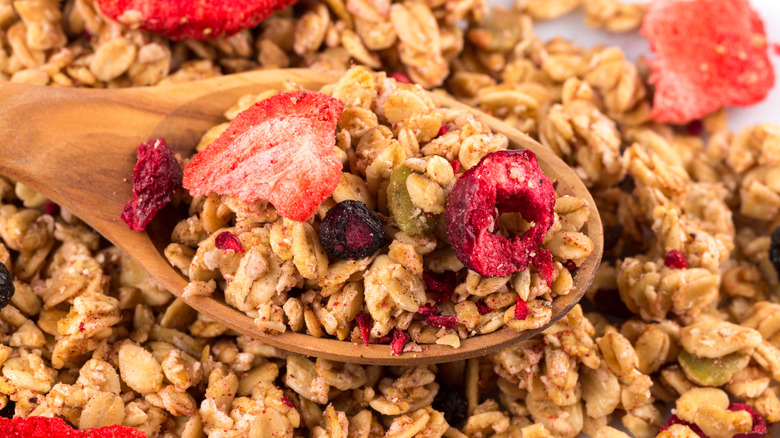 closeup of multigrain granola in and around spoon