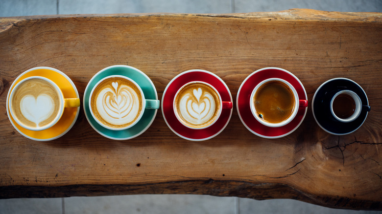 Top-down view of several different types of espresso drinks