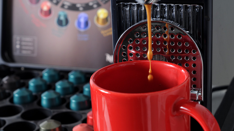 brewing espresso with Nespresso pods in background