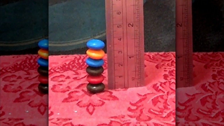 stack of M&Ms next to ruler