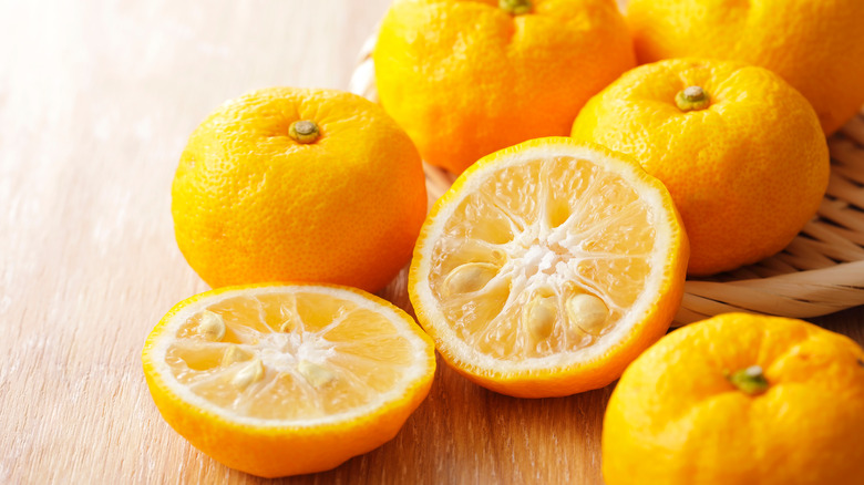 halved yuzu on wooden table