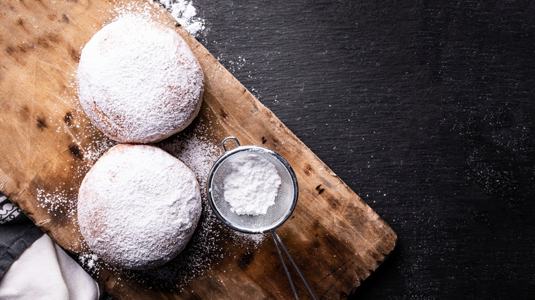 two donuts covered in powdered sugar