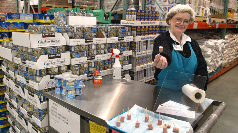 person offering sausage samples at a Costco stand