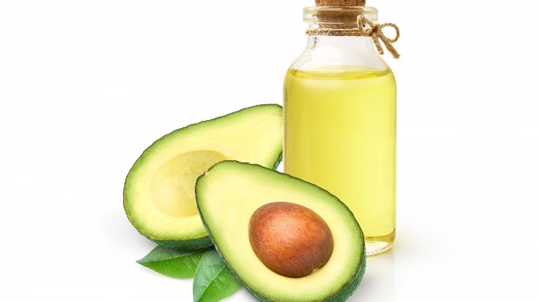 halved avocado next to oil