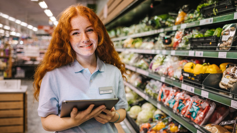 Woman with tablet in grocery store