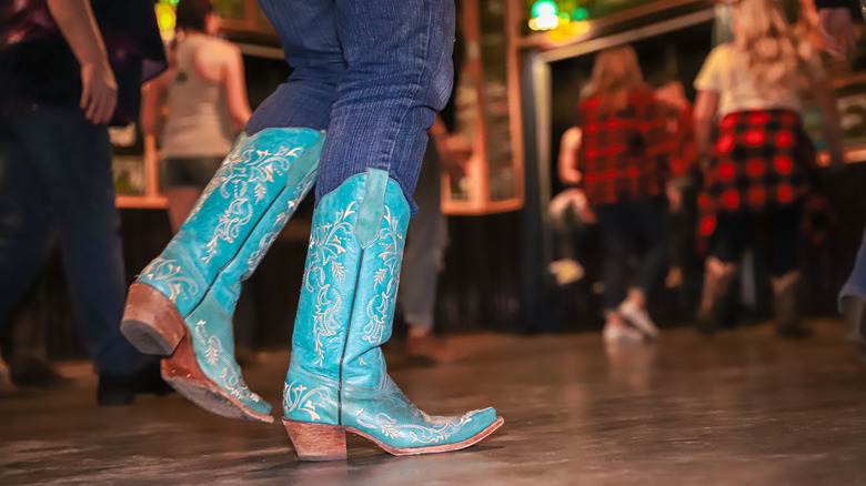 woman in blue boots line dancing