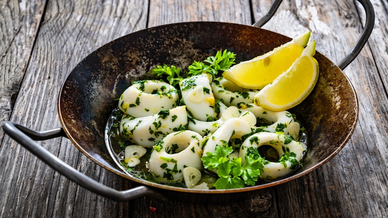 pan of calamari with parsley and lemon