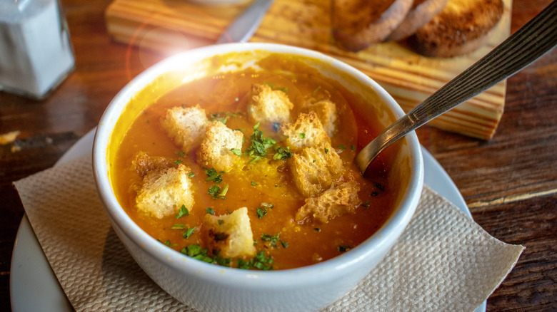 Creamy carrot soup served with croutons