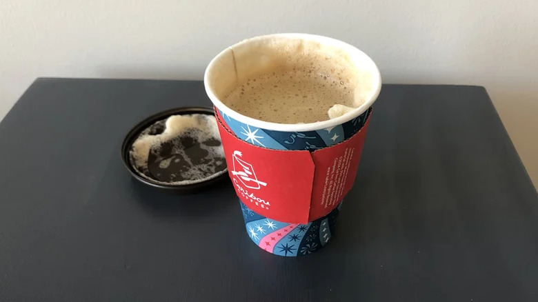 A Caribou Coffee cappuccino with the top off