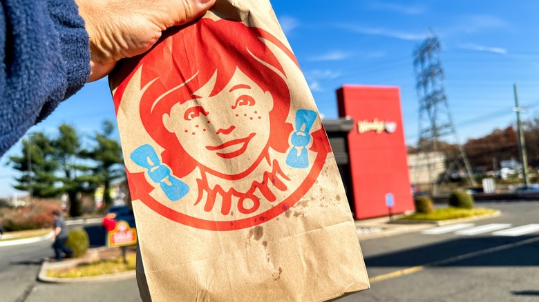 man holding Wendy's to-go order