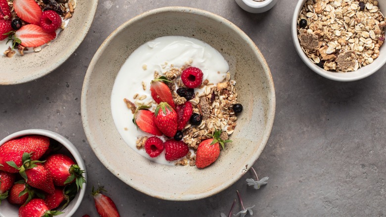 bowl of yogurt with fruit and nut toppings