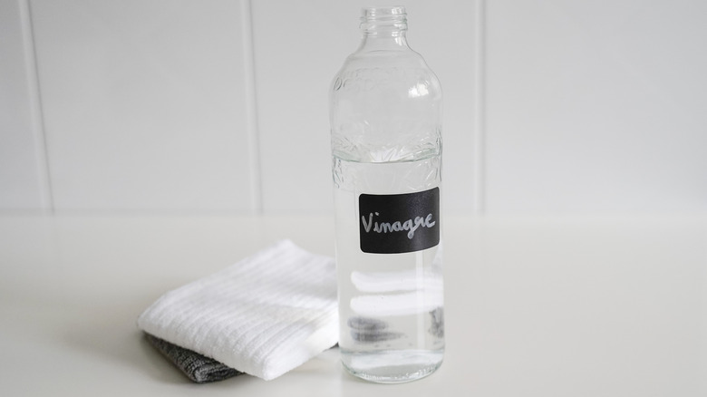 Bottle of vinegar in front of two folded towels