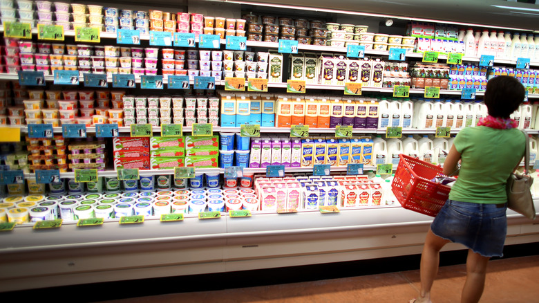 woman looking at milk fridge inside Trader Joe's