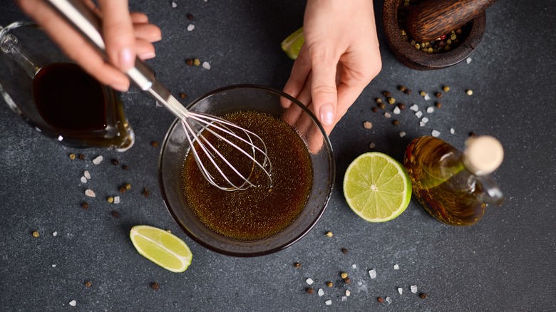 Woman mixing teriyaki sauce with lime