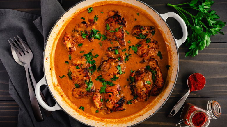 pot of chicken paprikash stew and bowl of smoked paprika