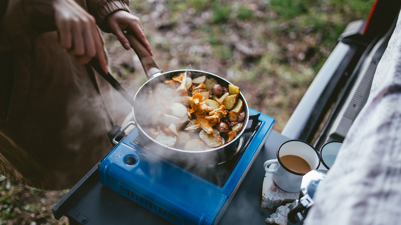 cooking breakfast on camping stove 