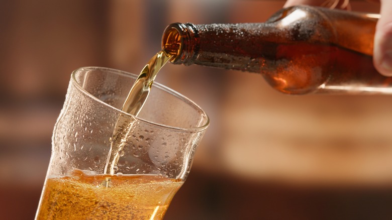 pouring beer from bottle to glass