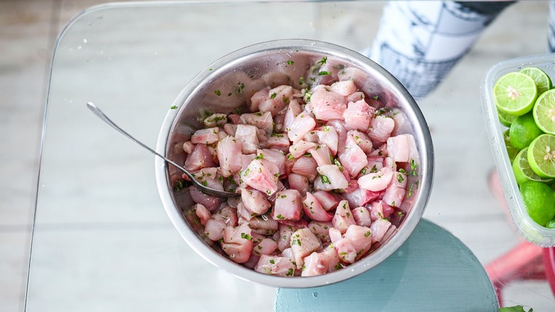 mixing ceviche in bowl