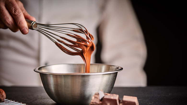 whisking melted chocolate in bowl