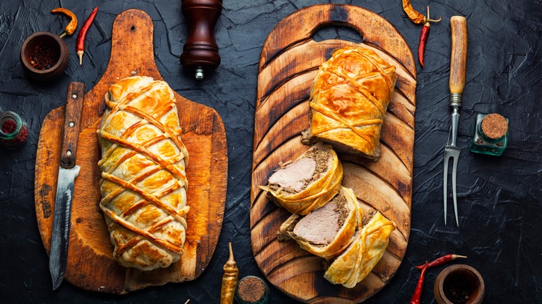 pork wellingtons on wooden boards