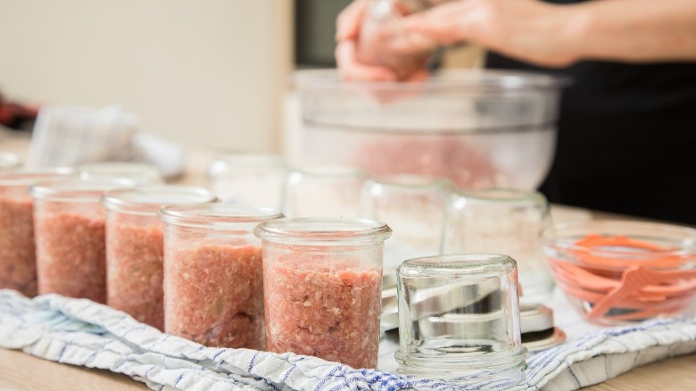 Person preparing meat for canning