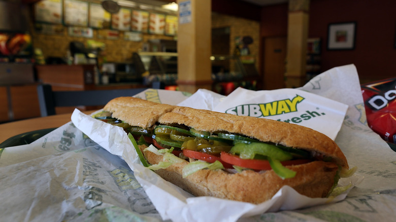 subway sandwich with the interior of restaurant