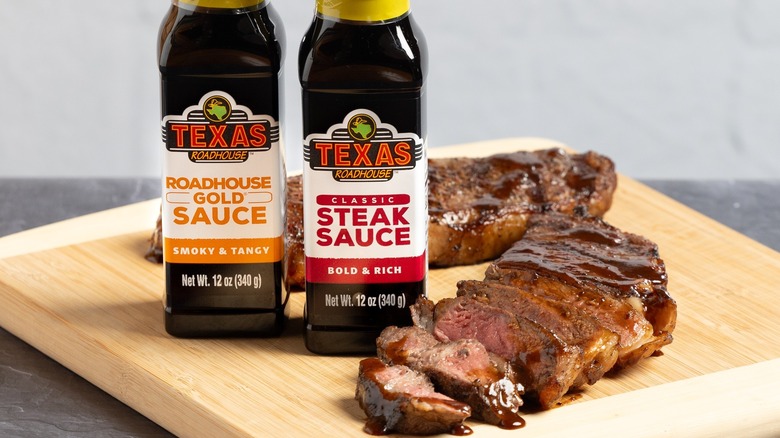 Bottles of Texas Roadhouse steak sauce with steak