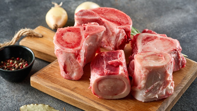 Beef marrow bones on wooden cutting board