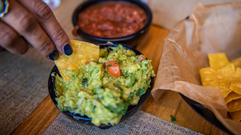 Guacamole and chips on a table