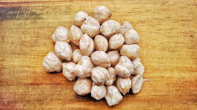 bunch of candlenuts on wooden table 