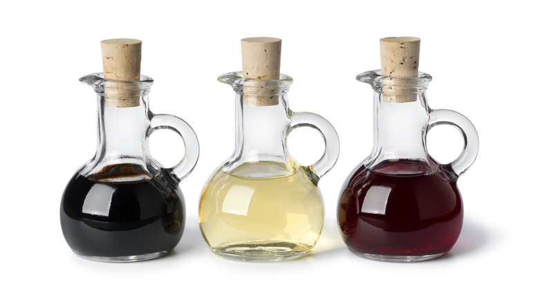 Different types of vinegar in corked bottles