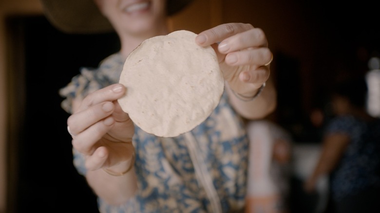 Hands holding tortilla