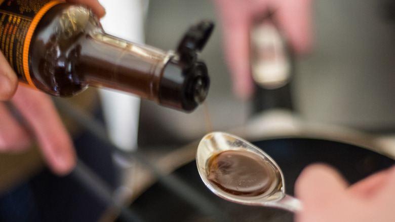 Worcestershire sauce is poured on spoon