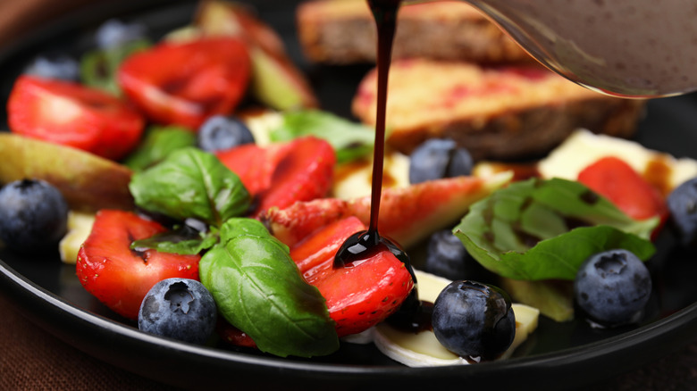 balsamic vinegar being drizzled on fruit