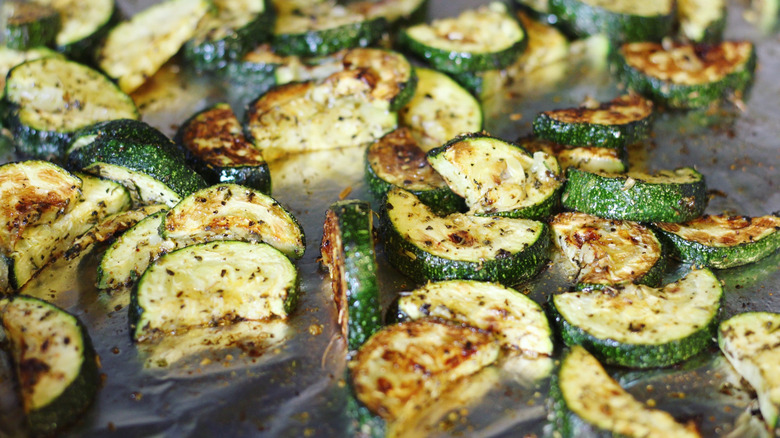 slices of oven roasted zucchini on a sheet pan