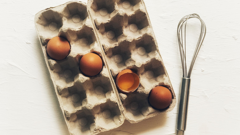 Container with eggs and whisk