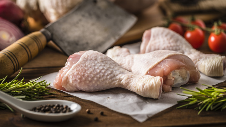 Chicken drumsticks on cutting board