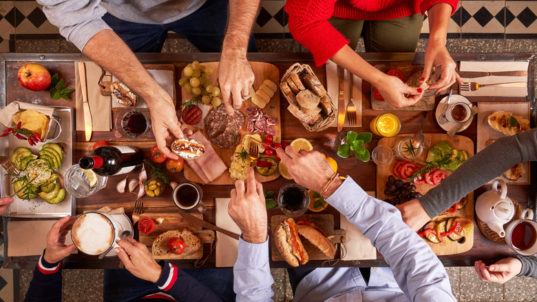 People eating snacks in a kitchen