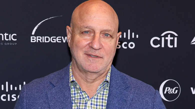 Tom Colicchio in blue suit with plaid button-up