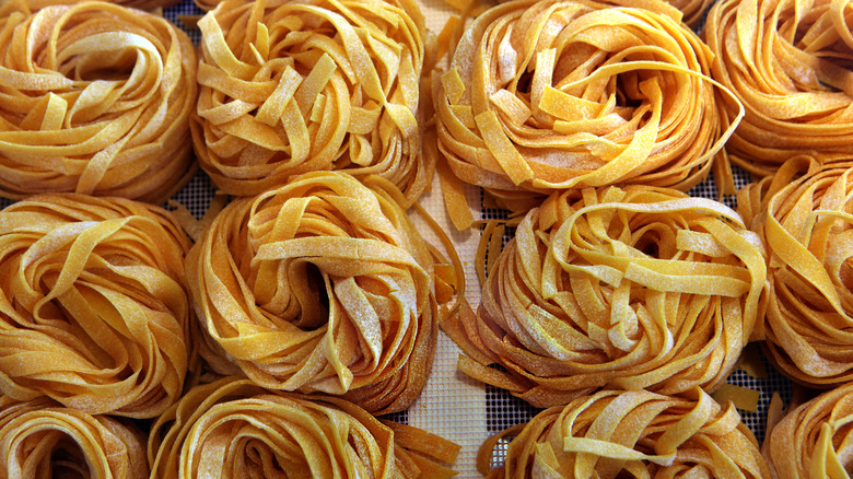 Four rows of fresh cut pasta