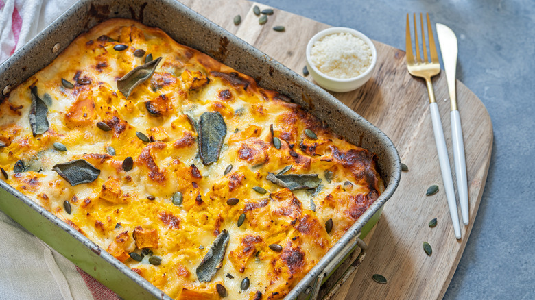 white lasagna on a wood board