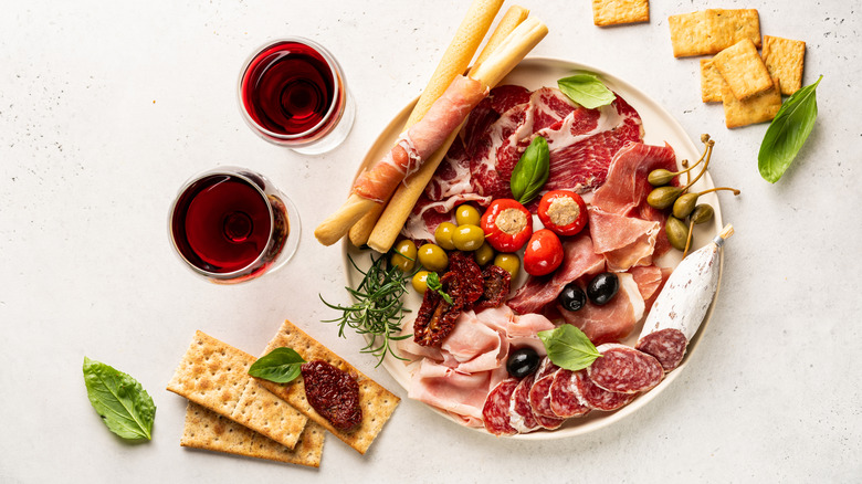 glasses of red wine and charcuterie board