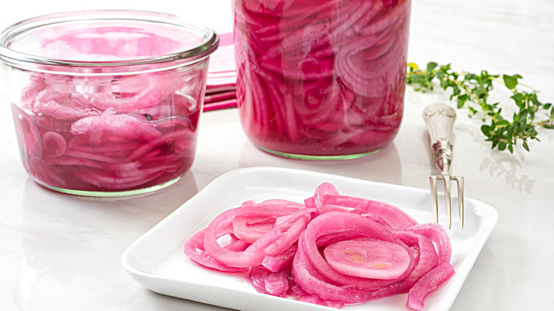 pickled purple onions in jar, bowl, and on white dish