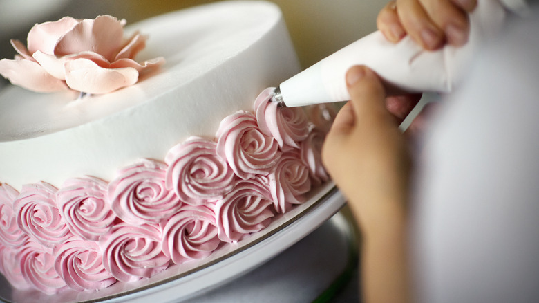 Piped decorations on the side of a cake