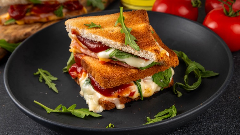 Grilled cheese with sauce and arugula